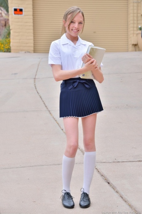 Tiny teen bares her little butt in the schoolyard and toys her bald beaver 98974553