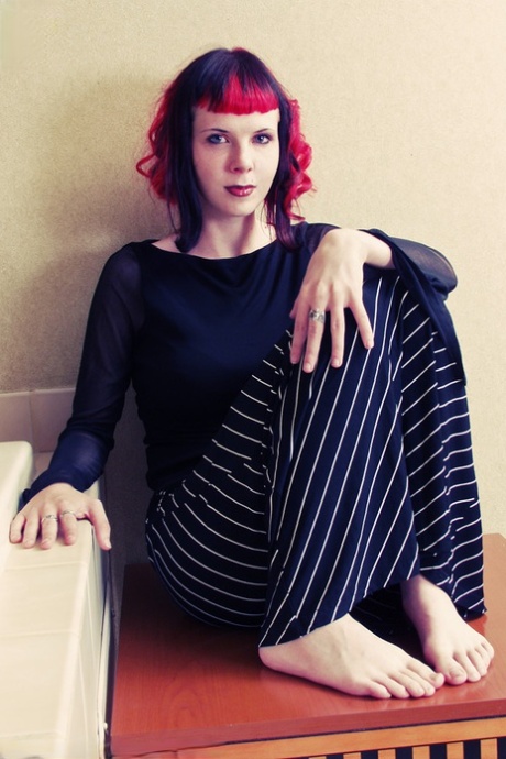 Pretty goth girl Szandora gets completely naked atop an end table 83385499