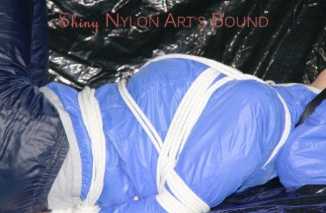 White girl with red nails is left gagged and tied up in a nylon coat and pants 62705274