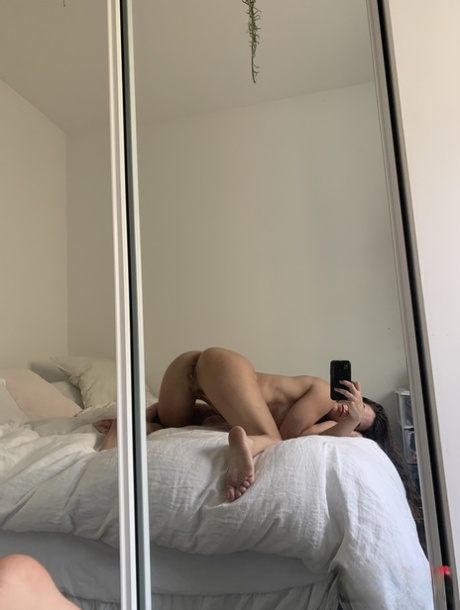Amateur model holds her bare ass during a series of nude selfies 15441204